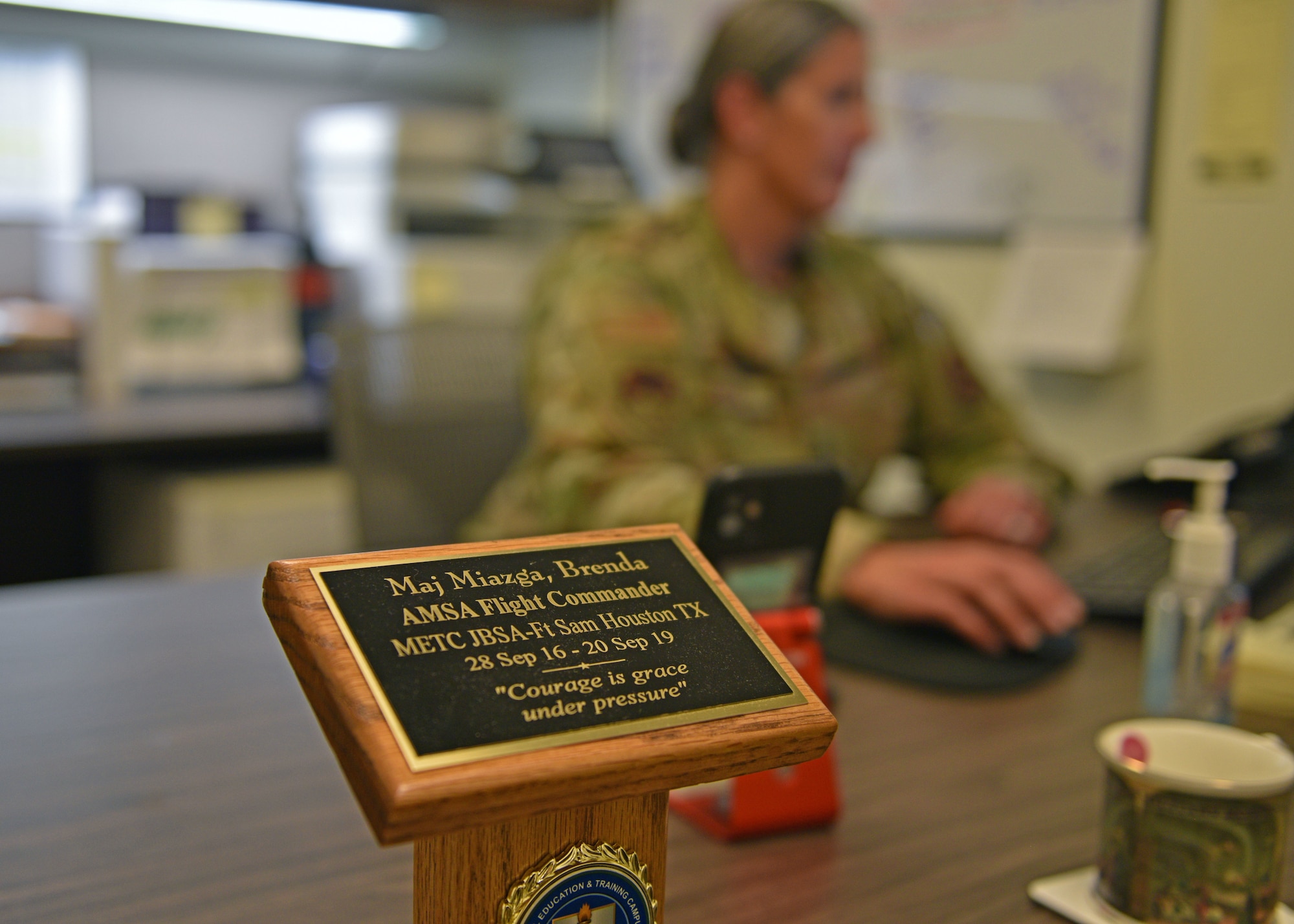 U.S. Air Force Lt. Col. Brenda Miazga, 17th Operational Medical Readiness Squadron commander’s plaque sits at her desk as a memento of her past role as flight commander, Goodfellow Air Force Base, Texas, July 12, 2022. Miazga has been active duty in the Air Force since 2012. (U.S. Air Force photo by Senior Airman Ashley Thrash)