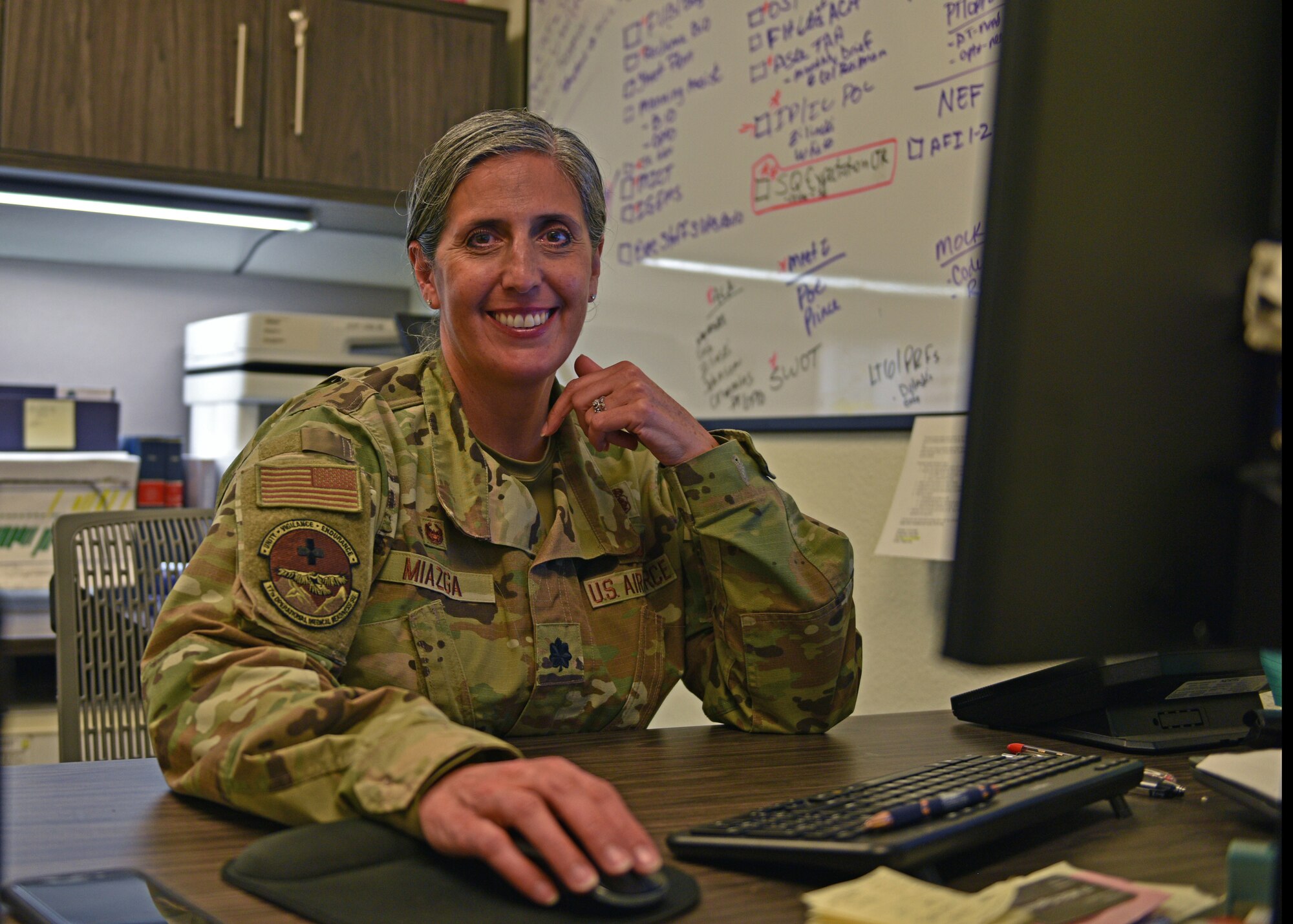 U.S. Air Force Lt. Col. Brenda Miazga, 17th Operational Medical Readiness Squadron commander, poses for a photo at her desk at Goodfellow Air Force Base, Texas, July 12, 2022. Miazga has served 32 years now spanning across the reserve, the inactive ready reserve, and active duty. (U.S. Air Force photo by Senior Airman Ashley Thrash)