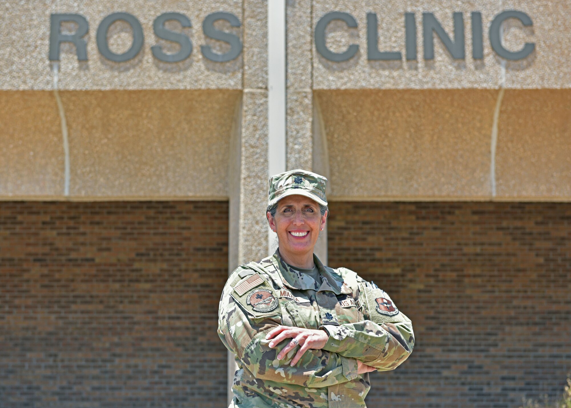U.S. Air Force Lt. Col. Brenda Miazga, 17th Operational Medical Readiness Squadron commander, poses for a photo in front of the Ross Clinic at Goodfellow Air Force Base, Texas, July 12, 2022. Miazga is in charge of ambulatory health services for nearly 26,000 patients in the community and ensures the nurses and medical technicians are prepared for anything that comes their way. (U.S. Air Force photo by Senior Airman Ashley Thrash)