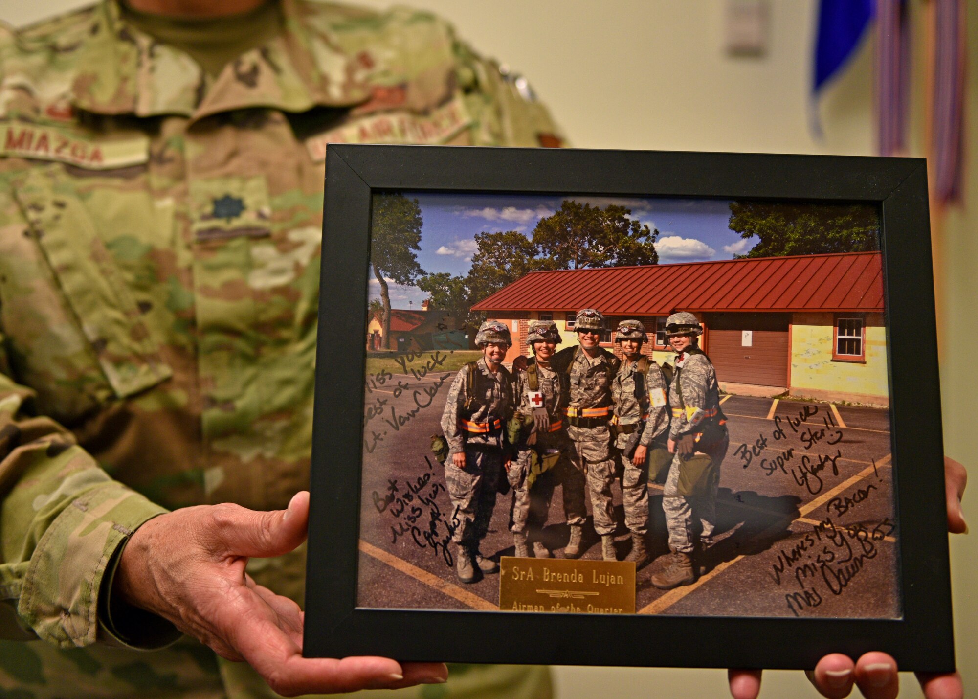 U.S. Air Force Lt. Col. Brenda Miazga, 17th Operational Medical Readiness Squadron commander, shows a photo of when she was an enlisted Airman, Goodfellow Air Force Base, Texas, July 12, 2022. Miazga originally enlisted into the Air Force as a C-130 guidance and control technician. (U.S. Air Force photo by Senior Airman Ashley Thrash)