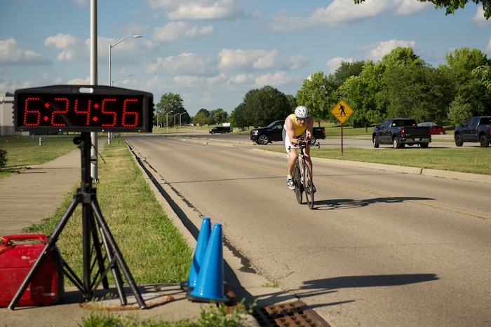 A rider crosses the finish line with a time of 6:24:56