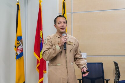 U.S. Air Force Lt. Col. Tyler “Mask” Stark holding microphone in front of audience