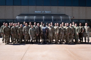 A group of 30 military members in uniform pose for a group photo
