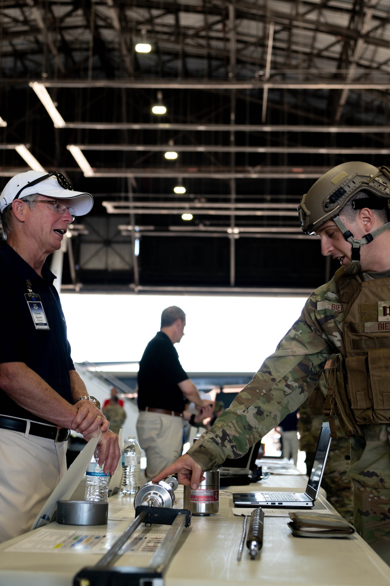 Civilian representative and service member observe display at an industry event on Scott Air Force Base Illinois, July 13, 2022.