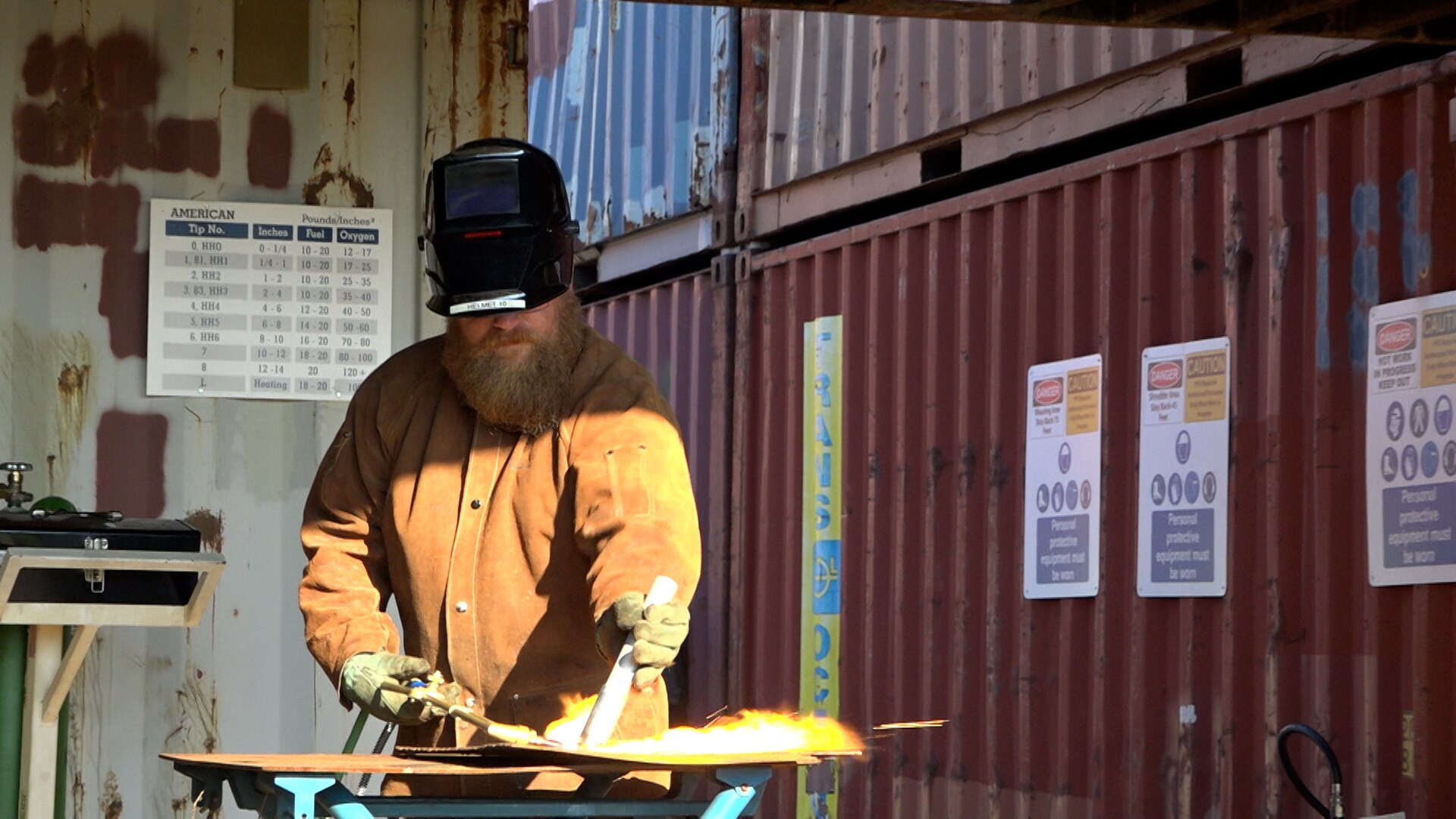 Man uses cutting system to cut steel