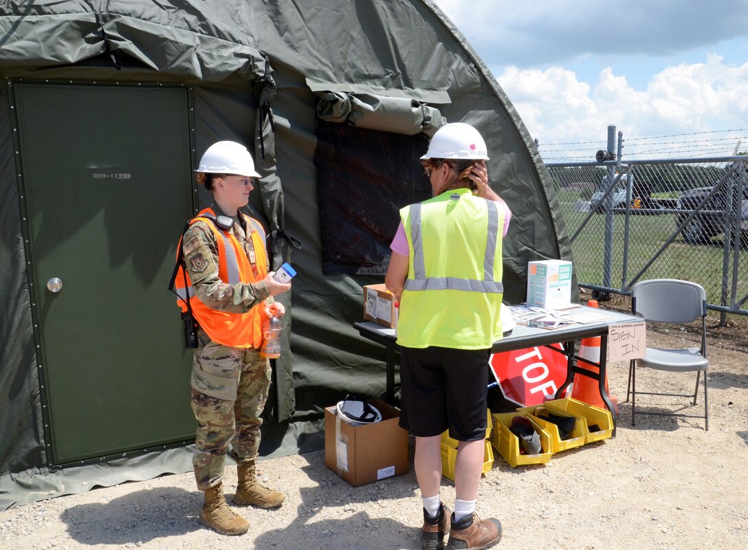 medic hands supplies to another female worker