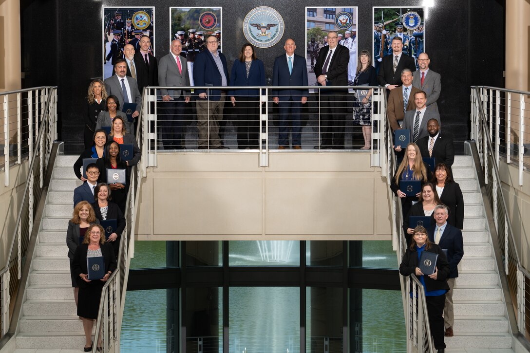 29 people in business suits standing on stairs