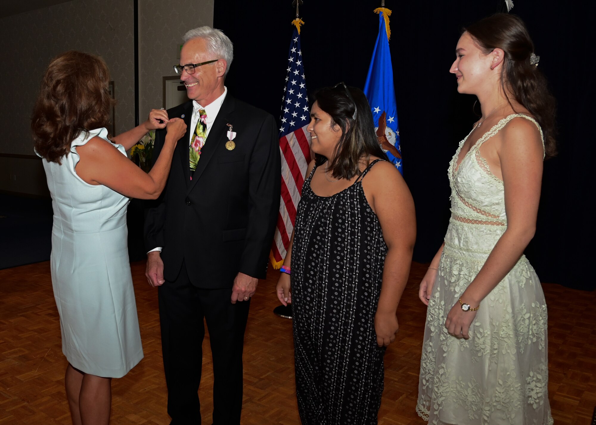 Kathleen Cortopassi pinned Ronald B. Cortopassi, 30th Space Wing executive director, his retirement pin at Vandenberg Space Force Base, Calif., July 20, 2022. (U.S. Space Force photo by Airman 1st Class Rocio Romo)