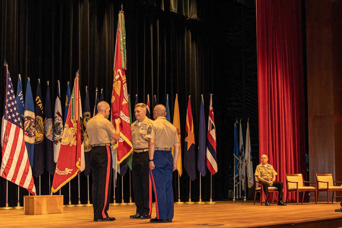 U.S. Marine Corps Maj. Gen. Jason Q. Bohm (left), the former commanding general of Marine Corps Recruiting Command, and Maj. Gen. William J. Bowers (middle) , the Commanding General of Marine Corps Recruiting Command, and Sgt. Maj. Adan F. Moreno, the sergeant major of Marine Corps Recruiting Command, perform the passing of colors during the MCRC change of command ceremony at Marine Corps Base Quantico, Va., on July 21, 2022. Major General Bohm served as the commanding general of MCRC from July 2020 to July 2022 and will assume command as the Inspector General for the Marine Corps. (U.S. Marine Corps photo by Lance Cpl. Gustavo Romero)