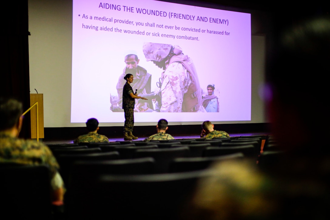 U.S. service members participate in a brief prior to an upcoming night convoy exercise, Marine Corps Base Hawaii, July 18, 2022. The brief was conducted in order to familiarize and inform the participants on the guidelines of the exercise, including law of war, defensive operations, convoy operations, action drills and night vision operations. (U.S. Marine Corps photo by Cpl. Israel Ballaro)