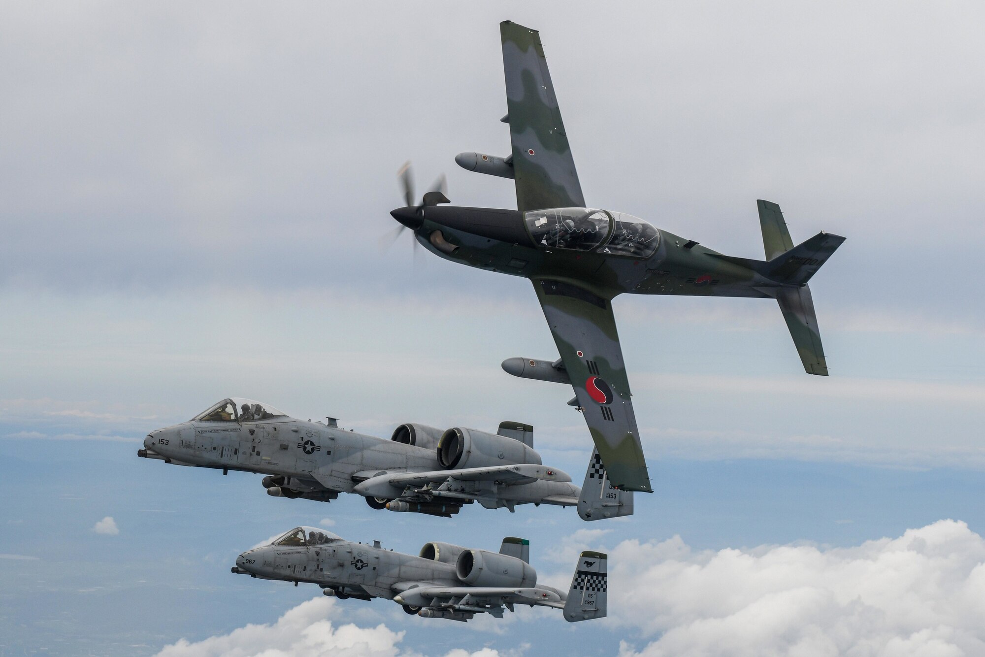 A Republic of Korea Air Force KA-1 Woongbi assigned to the 237th Fighter Squadron flies alongside two 25th Fighter Squadron A-10 Thunderbolt IIs during Buddy Squadron 22-5