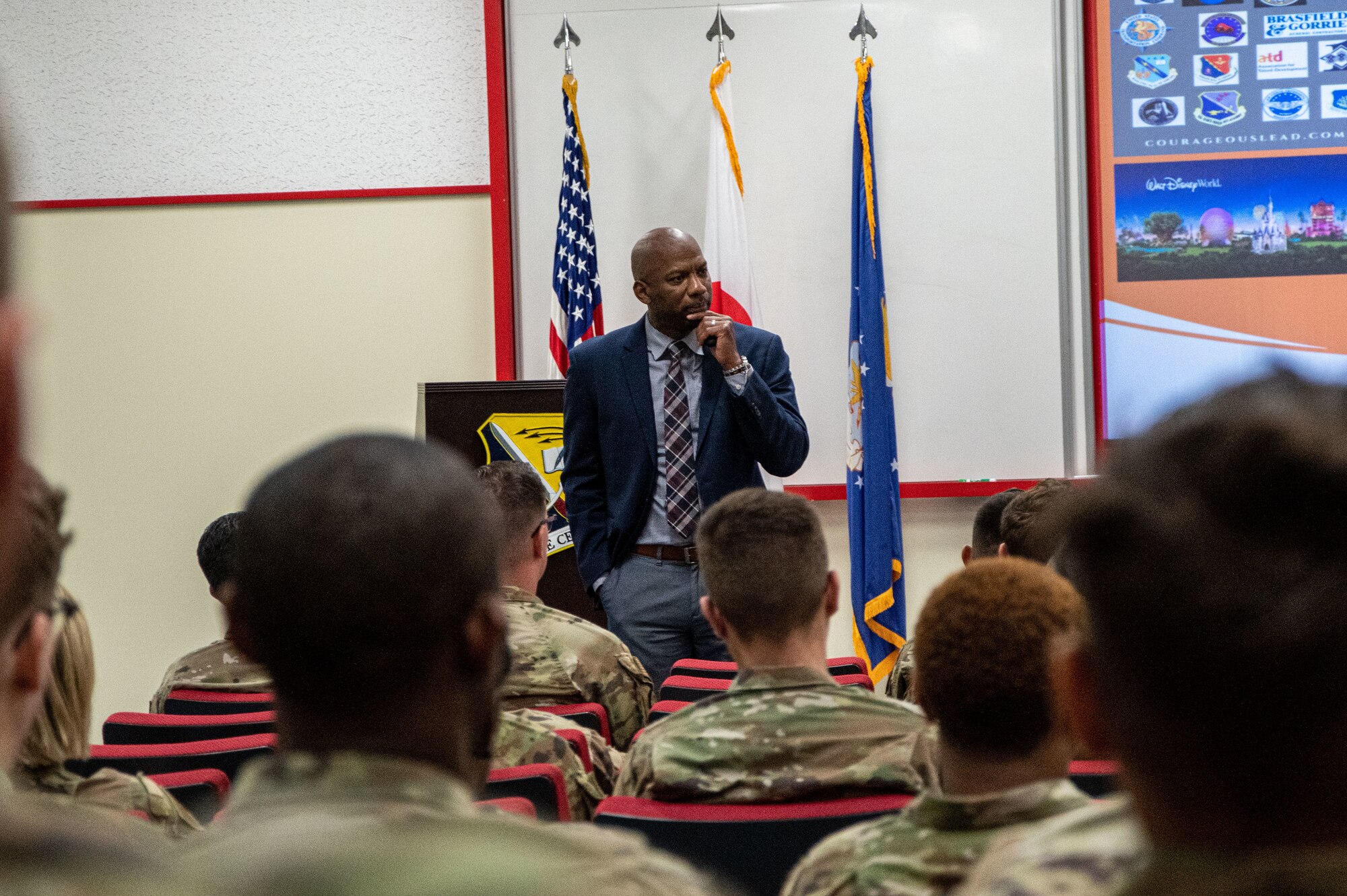 Retired Airman speaks to a room of Airmen.