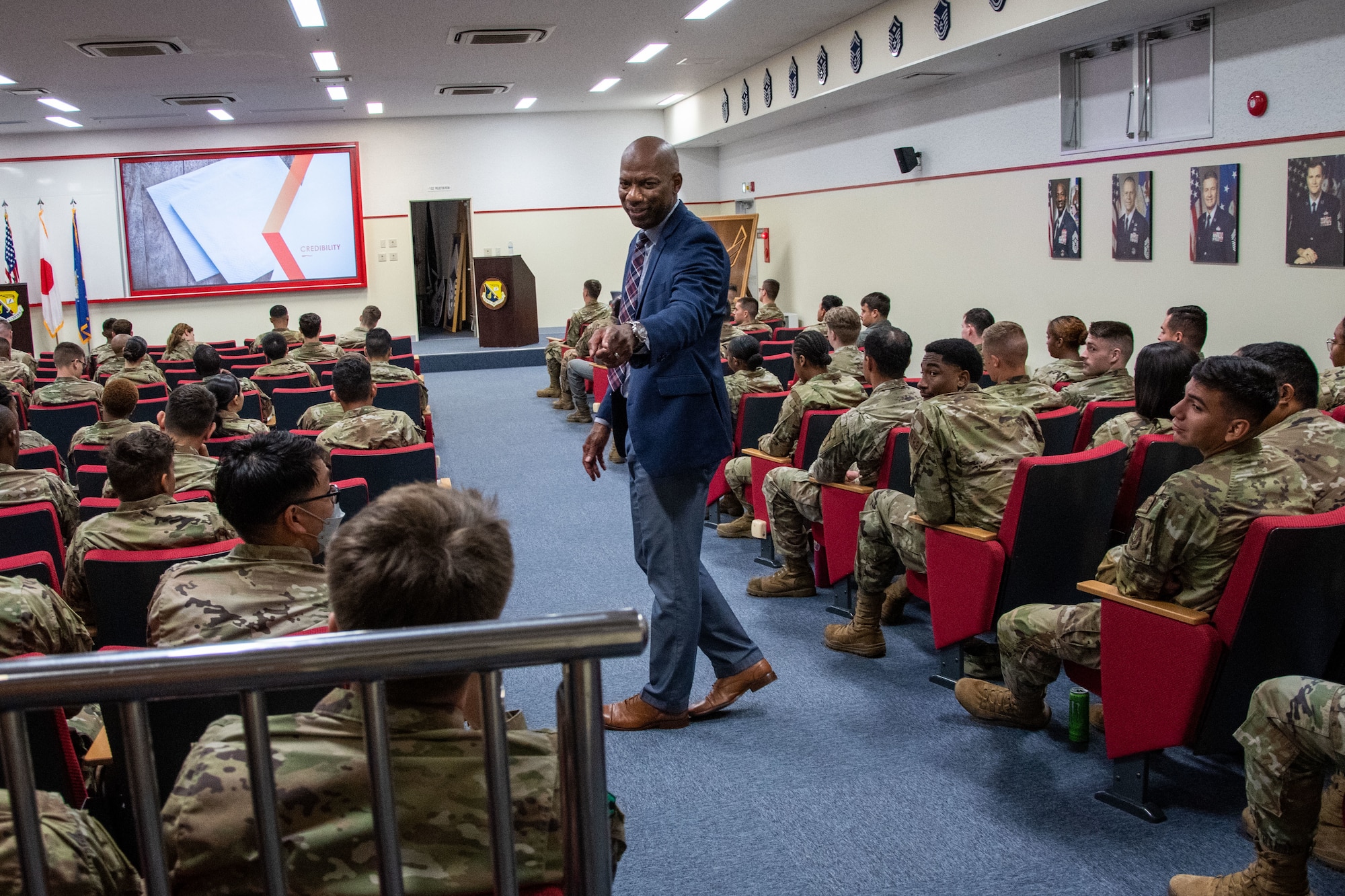 Retired Airman speaks to a room of Airmen.