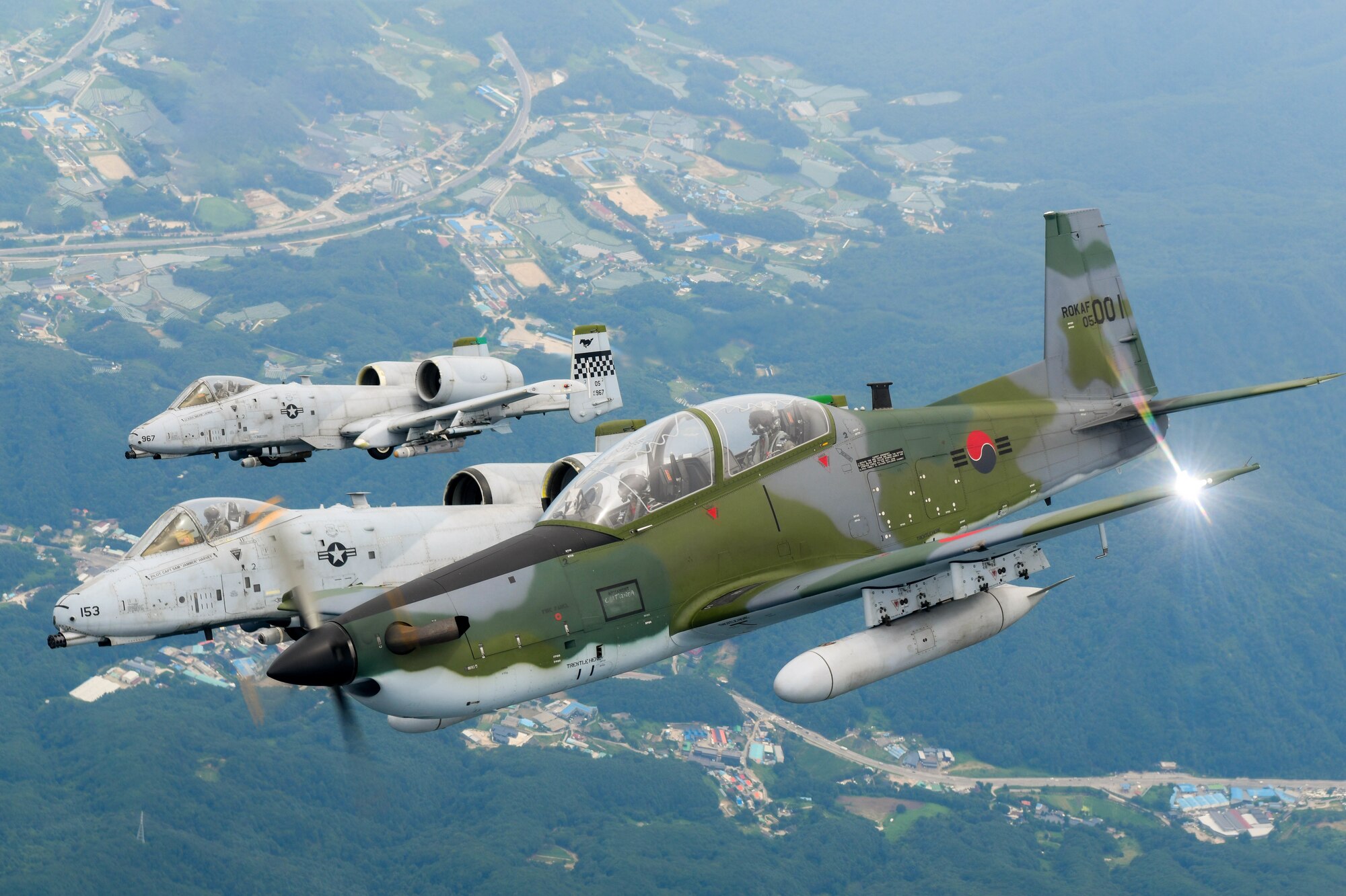 A Republic of Korea Air Force KA-1 Woongbi assigned to the 237th Fighter Squadron flies alongside two 25th Fighter Squadron A-10 Thunderbolt IIs during Buddy Squadron 22-5