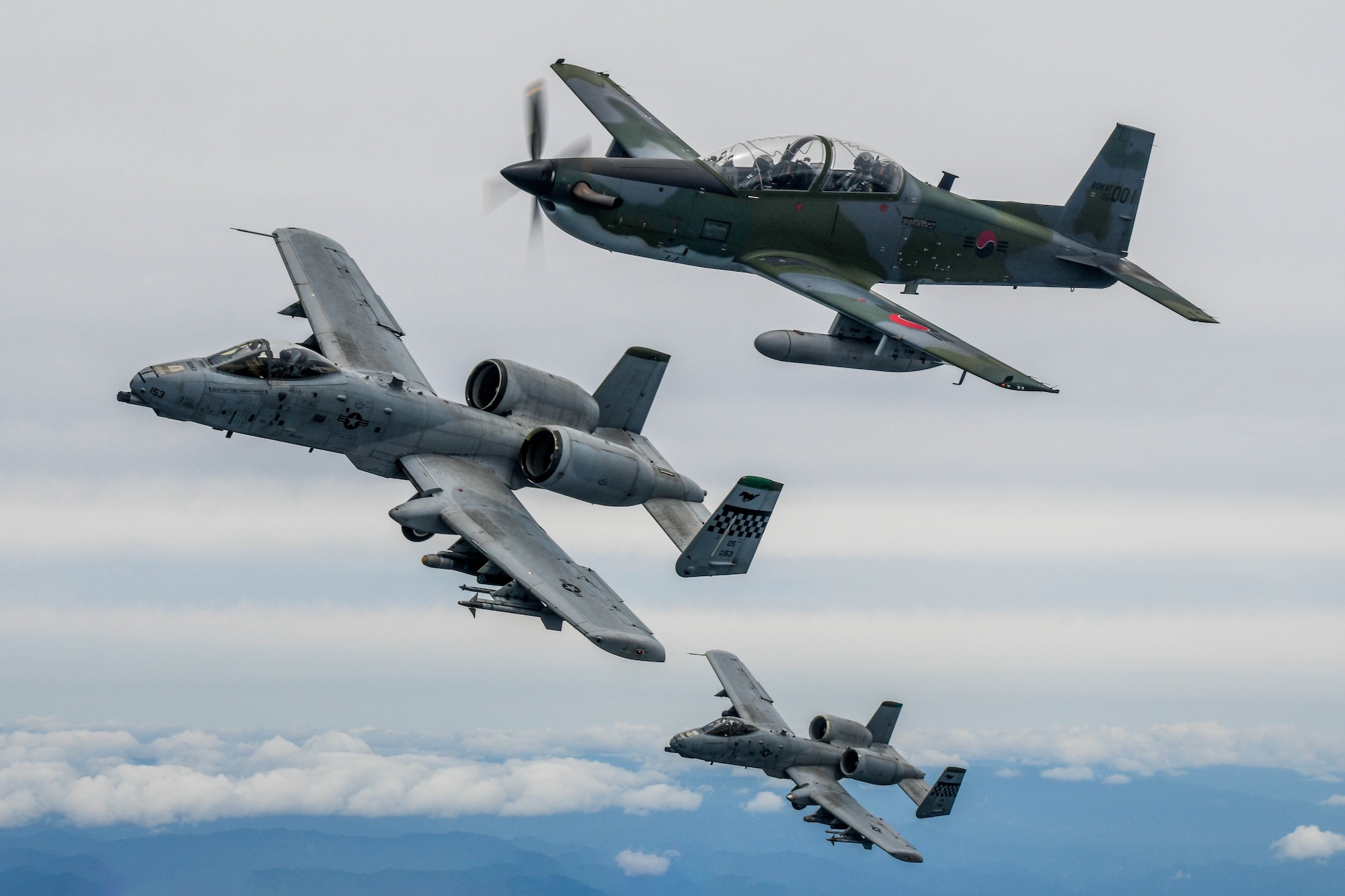 A Republic of Korea Air Force KA-1 Woongbi assigned to the 237th Fighter Squadron flies alongside two 25th Fighter Squadron A-10 Thunderbolt IIs during Buddy Squadron 22-5