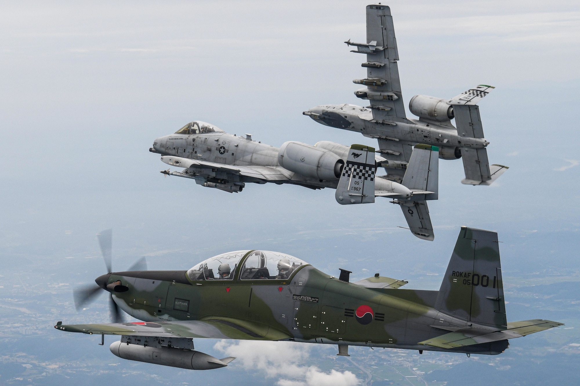 A Republic of Korea Air Force KA-1 Woongbi assigned to the 237th Fighter Squadron flies alongside two 25th Fighter Squadron A-10 Thunderbolt IIs during Buddy Squadron 22-5