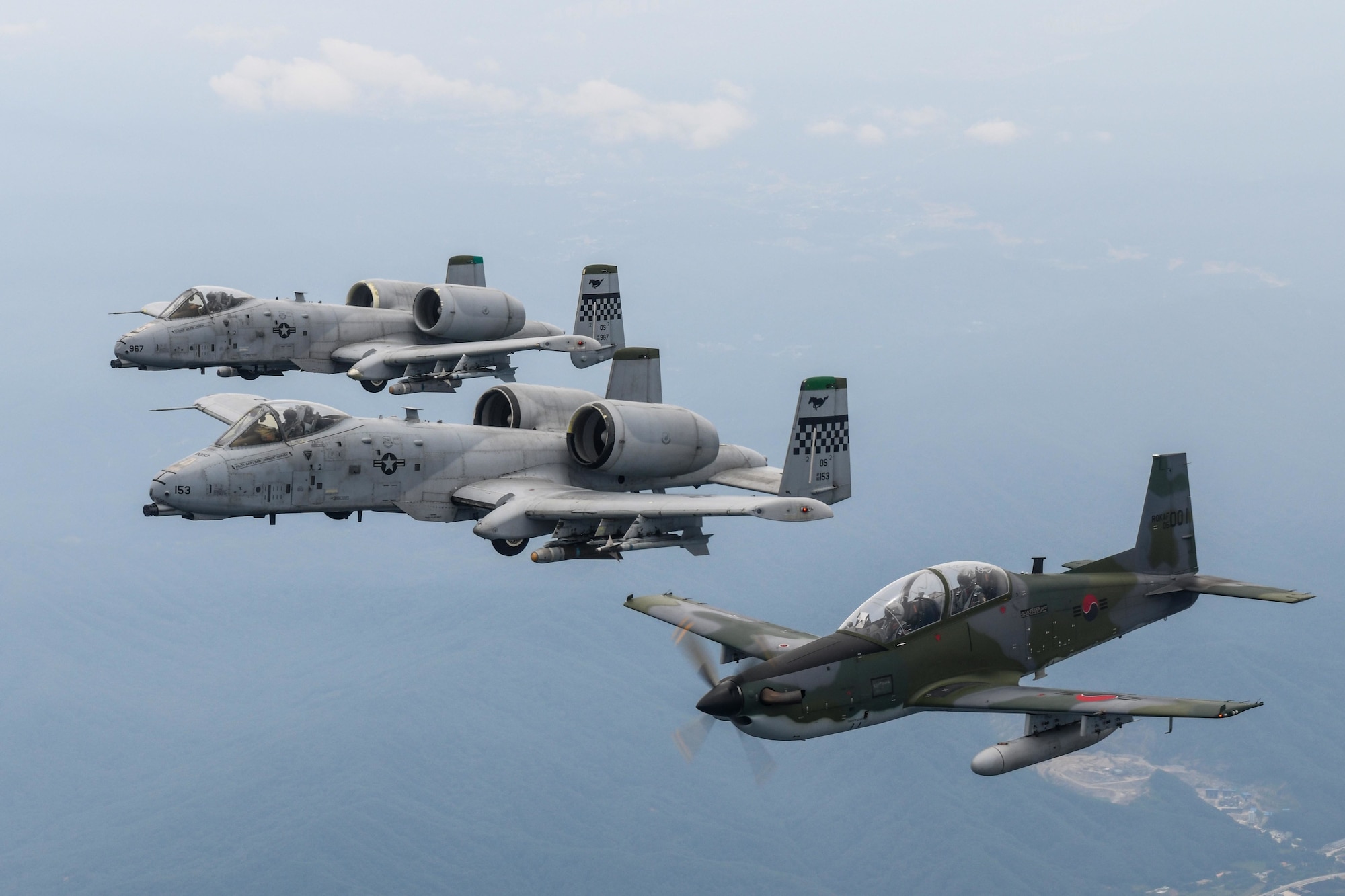 A Republic of Korea Air Force KA-1 Woongbi assigned to the 237th Fighter Squadron flies alongside two 25th Fighter Squadron A-10 Thunderbolt IIs during Buddy Squadron 22-5