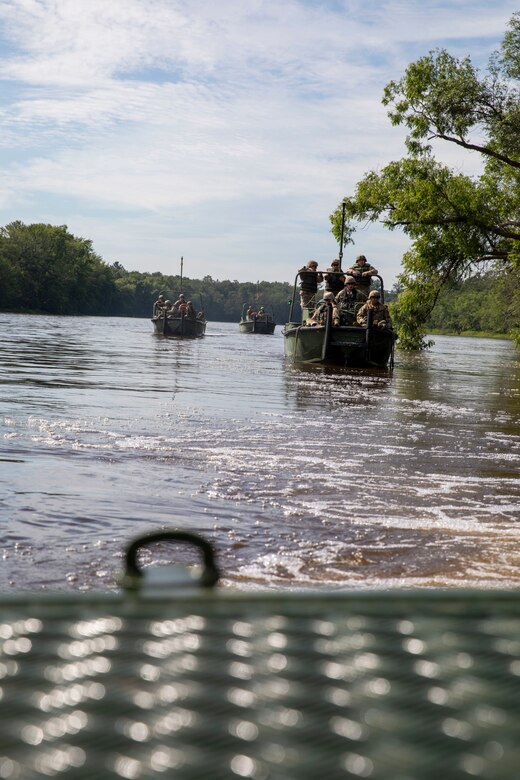 Three boats carry groups of soldiers.