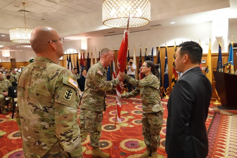 Brig. Gen. Kirk E. Gibbs, U.S. Army Corps of Engineers (USACE) Pacific Ocean Division (POD) commanding general, passes the District colors to Col. Heather A. Levy, USACE Far East District (FED) commander, during a change of command ceremony held at River Bend Golf Course, USAG Humphreys, Republic of Korea, July 19. Levy arrived at FED from the Army War College, where she earned a master’s degree in strategic studies, and was recognized as a distinguished graduate. (Photo Credit: Susan Lee)
