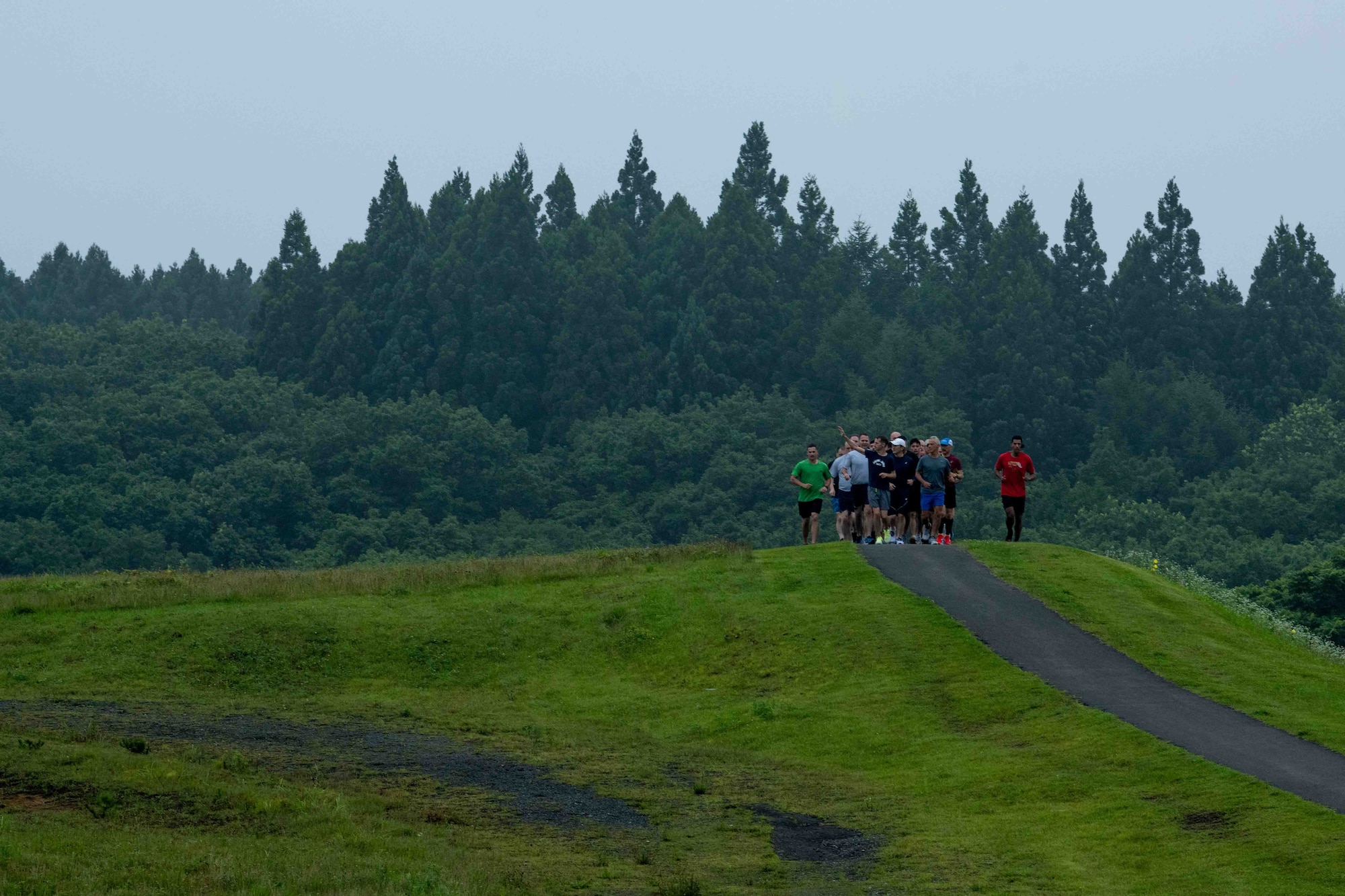 Rahm Emanuel, U.S. Ambassador to Japan, and Team Misawa members jog along the flight line running trail during the ambassador’s visit at Misawa Air Base, Japan, July 22, 2022.