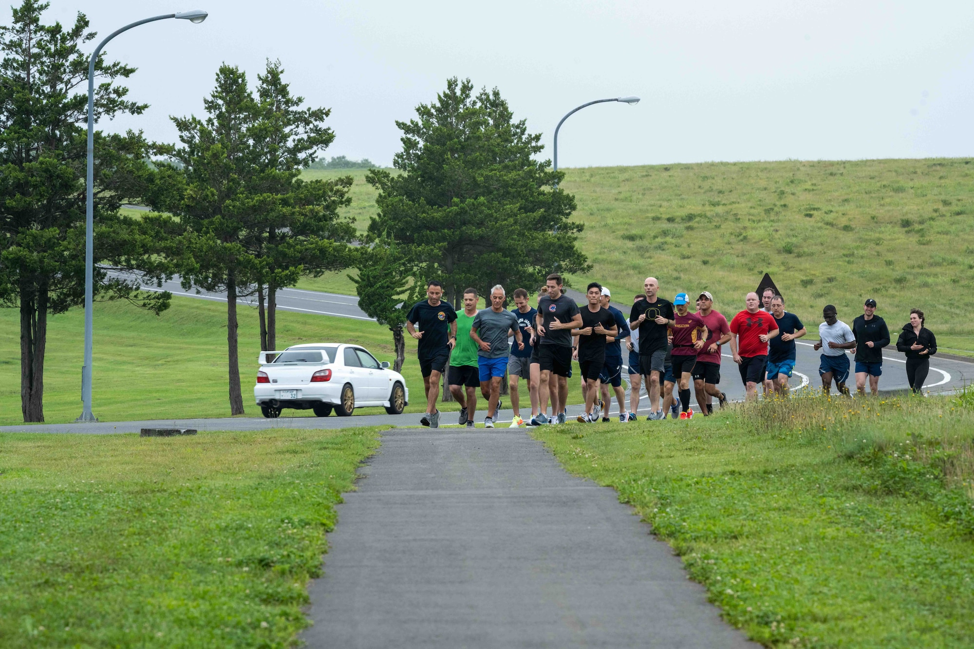 Rahm Emanuel, U.S. Ambassador to Japan, and Team Misawa members jog along the flight line running trail during the ambassador’s visit at Misawa Air Base, Japan, July 22, 2022.
