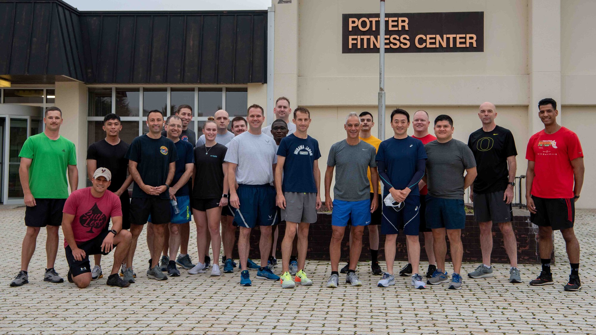 Rahm Emanuel, U.S. Ambassador to Japan, and Team Misawa members pose for a photo prior to running a 5K during the ambassador’s visit at Misawa Air Base, Japan, July 22, 2022.