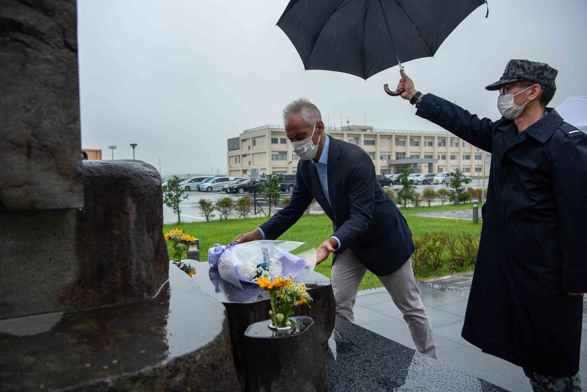 Rahm Emanuel, U.S. Ambassador to Japan, places flowers on a memorial during his visit to Misawa Air Base, Japan, July 22, 2022.
