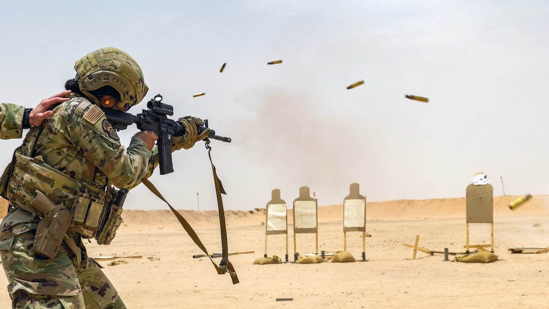 U.S. Air Force Master Sgt. Kourtney Haggins, 378th Expeditionary Security Forces Squadron first sergeant, fires an M4 carbine on full auto