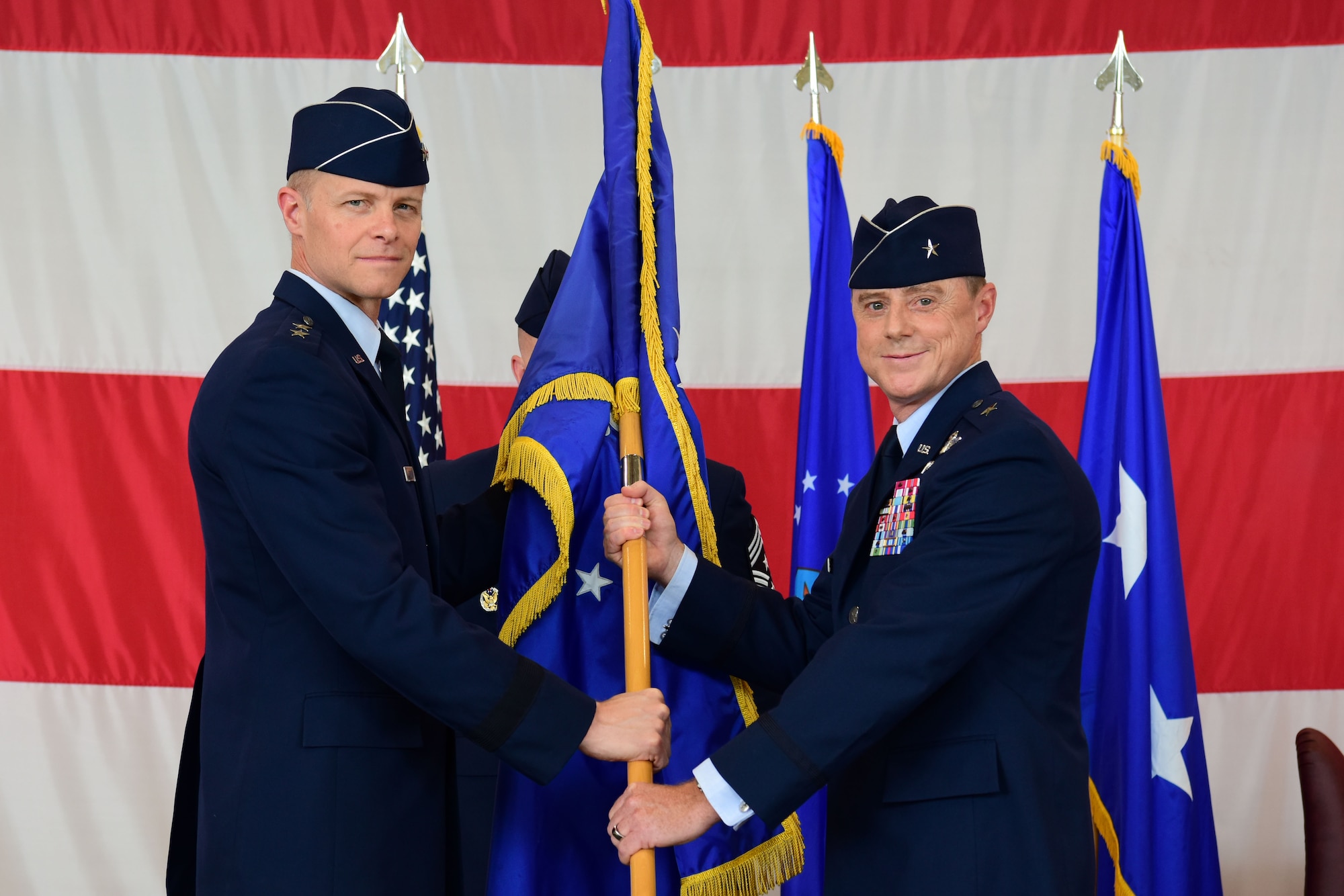 U.S. Air Force Brig. Gen. Tad D. Clark, 31st Fighter Wing incoming commander, right, assumes command from Maj. Gen. Derek C. France, 3rd Air Force commander, left, during a change of command at Aviano Air Base