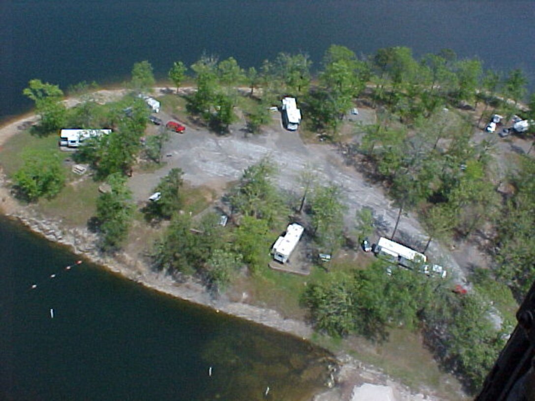 Aerial view of a campground on a lake.