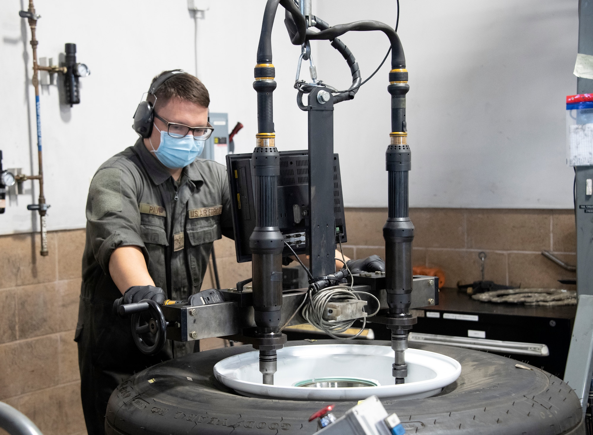 Senior Airman Joseph Palke, 60th Maintenance Squadron wheel and tire team member, uses a wheel assembly torquing system