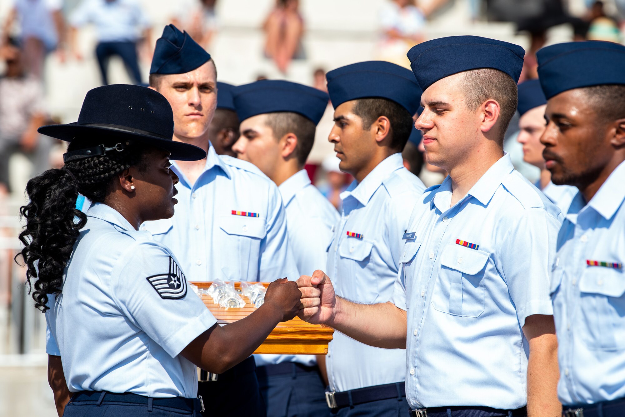 Tech. Sgt. Rachel Armstrong, 324th Training Squadron military training instructor, congratulates an Airman