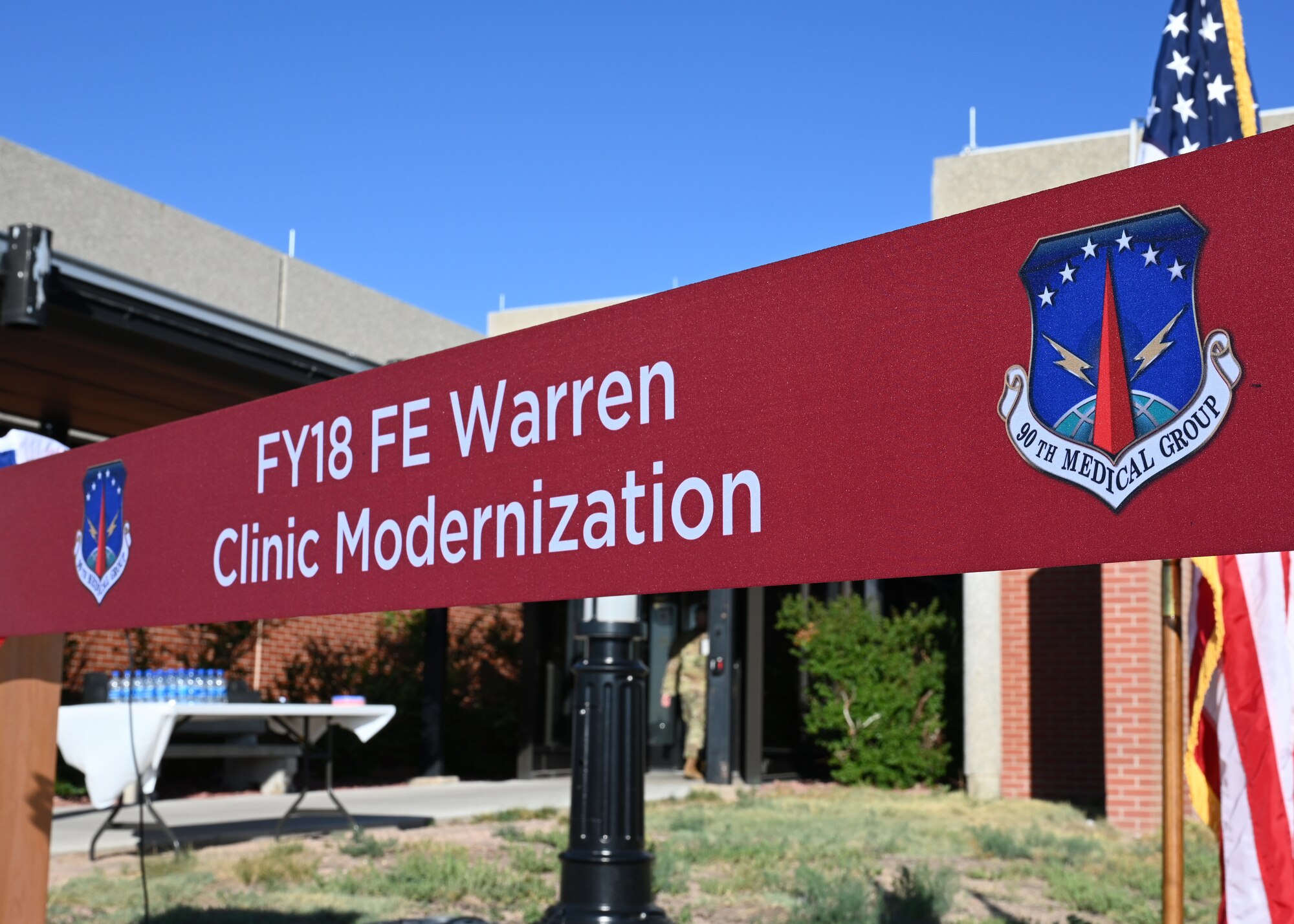 The ribbon waiting to be cut during a ribbon cutting ceremony on July 21, 2022, on F.E. Warren Air Force Base, Wyoming. The ribbon cutting ceremony signified the reopening of the base clinic after it underwent renovations to implement new improvements. (U.S. Air Force photo by Senior Airman Darius Frazier.)