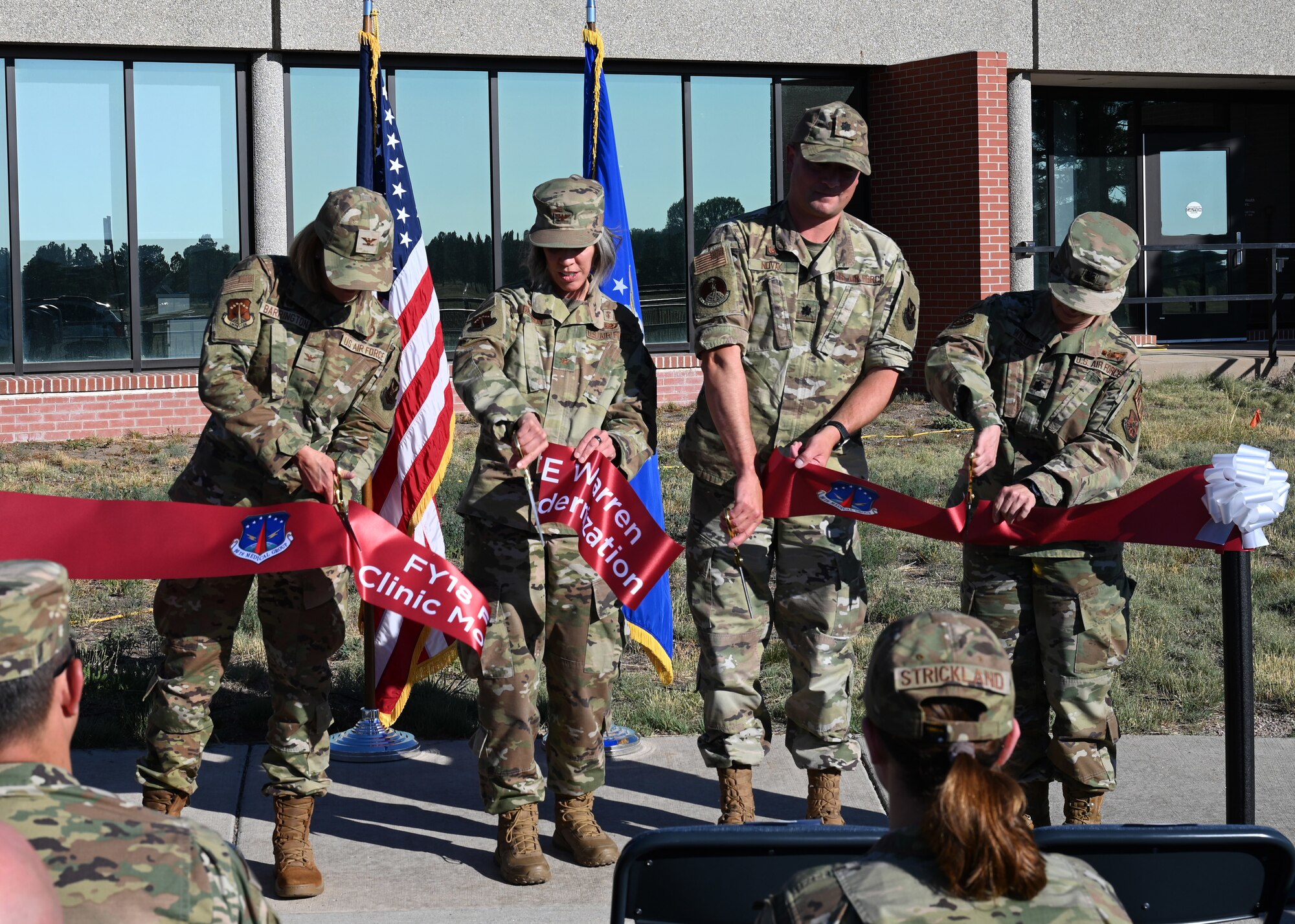 90th Missile Wing leadership cutting the ribbon during a ribbon cutting ceremony on July 21, 2022, on F.E. Warren Air Force Base, Wyoming. The ribbon cutting ceremony signified the reopening of the base clinic after it underwent renovations to implement new improvements. (U.S. Air Force photo by Senior Airman Darius Frazier.)