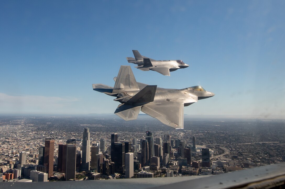 An F-35 Lightning II from the 461st Flight Test Squadron and an F-22 Raptor from the 411th Flight Test Squadron fly past Los Angeles, California, following a flyover during the 2022 MLB All-Star Game opening ceremony at Dodger Stadium. (Photo courtesy of Kyle Larson/Lockheed Martin)