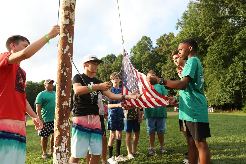 Campers fold the flag at retreat ceramony at the Kentucky National Guard (KYNG) Child and Youth Camp at the Lake Cumberland 4-H Camp in Nancy, Ky. on July 18-22, 2022. Each platoon is expected to participate in reveille and retreat. (U.S. Army phot by Pfc. Georgia Napier)