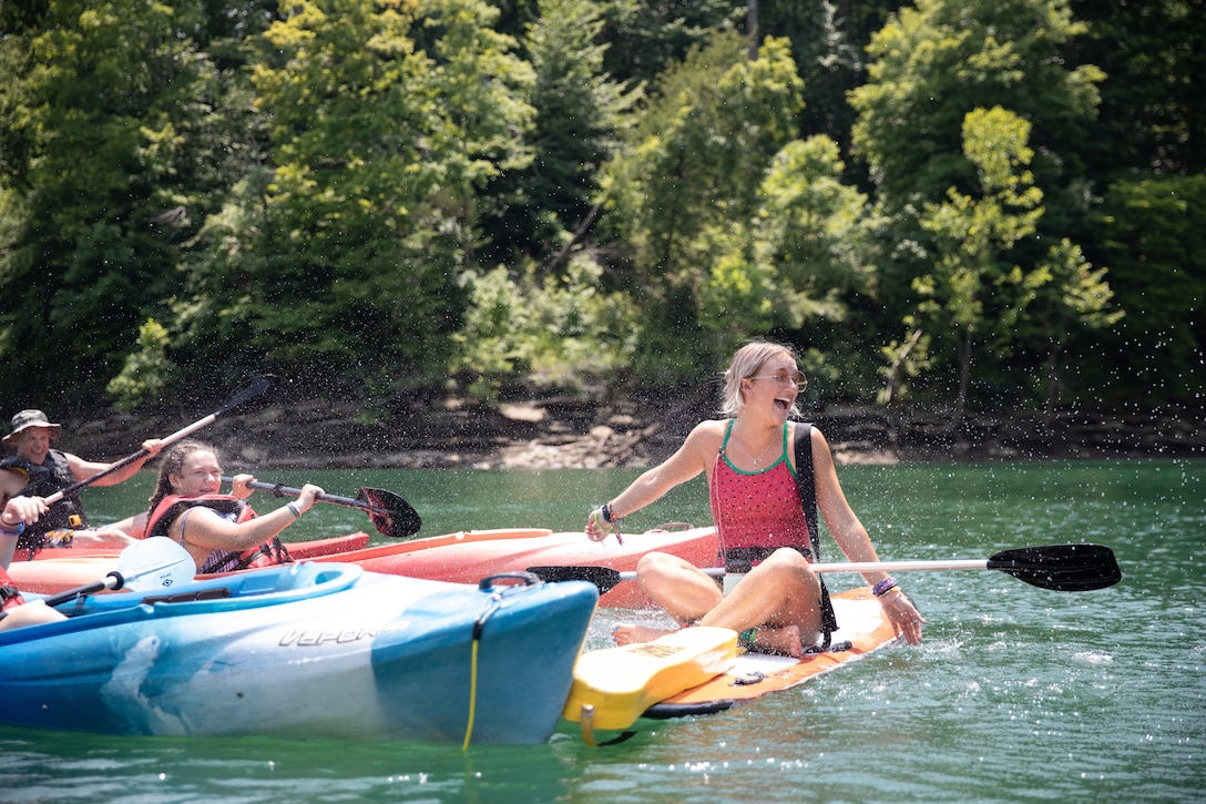 Julia Kromenacker, lifeguard and staff of the Lake Cumberland 4-H Camp, gets splashed by campers during the Kentucky National Guard Child and Youth Camp at Lake Cumberland 4-H Camp in Nancy, Ky. on July 21, 2022. The Child and Youth Camp is a KYNG sponsored, 4-H supported weeklong camp for children who have ties to the KYNG. (U.S. Army photo by Staff Sgt. Andrew Dickson).