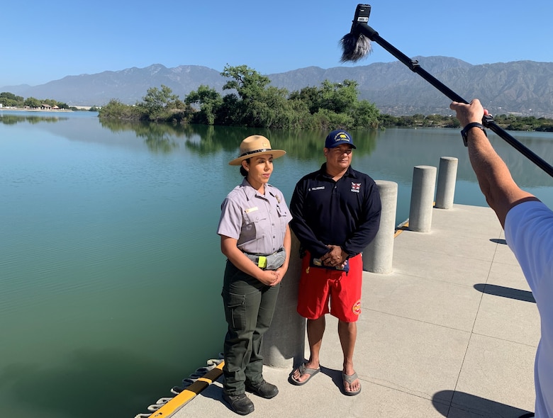 U.S. Army Corps of Engineers Los Angeles District Park Ranger and Annel Monsalvo and LA County Parks and Recreation Senior Lake Lifeguard Oscar Villagomez conduct a public service announcement in Spanish during a joint safety video production in Santa Fe Dam Recreational Park June 1 in LA County.