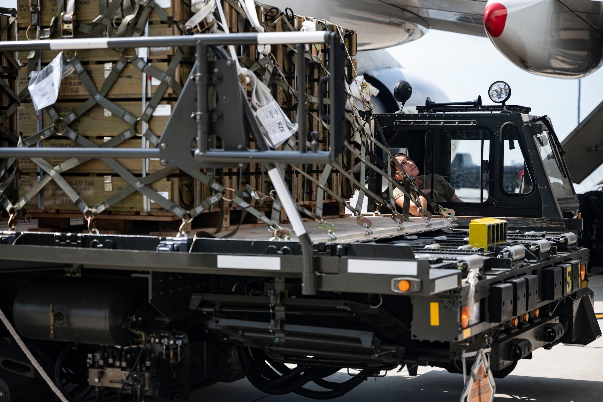 A Team Dover Airman from the 436th Aerial Port Squadron assists in loading ammunition onto a commercial plane bound for Ukraine during a security assistance mission at Dover Air Force Base, Delaware, July 21, 2022. The Department of Defense is providing Ukraine with critical capabilities to defend against Russian aggression under the Ukraine Security Assistance initiative (U.S. Air Force photo by Senior Airman Faith Schaefer)