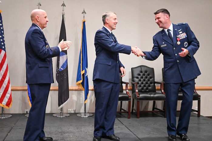 Middle, Col. Joseph J. Egresits, incoming 372nd Recruiting Group commander, shakes the hand of the outgoing 372nd RCG commander, Col. Layne D. Trosper, during a change of command ceremony