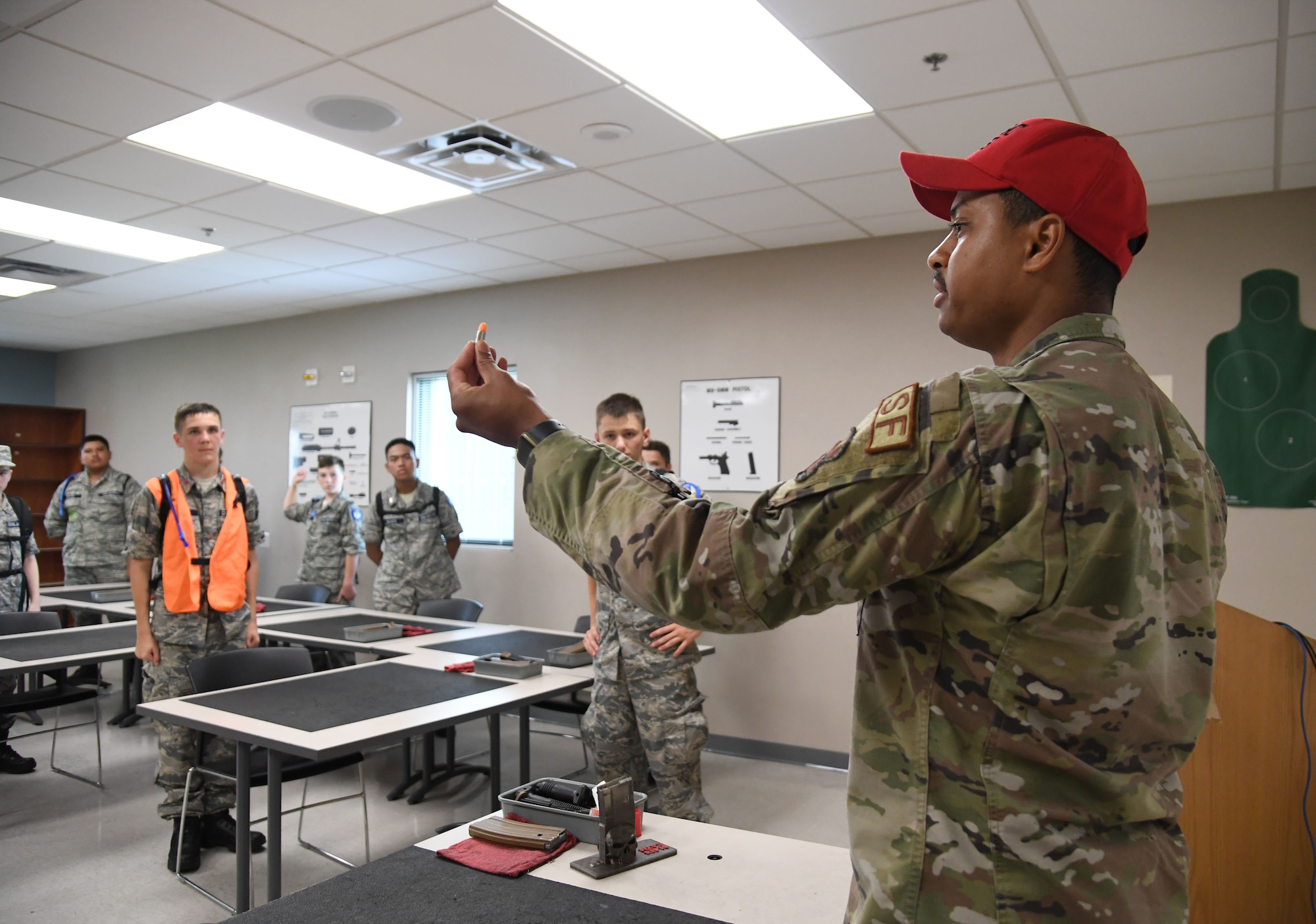U.S. Air Force Senior Airman Juan Duran, 81st Security Forces Squadron combat arms instructor, briefs Civil Air Patrol cadets on the training capabilities of the indoor firing range at Keesler Air Force Base, Mississippi, July 19, 2022. More than 50 cadets attended the Louisiana Wing Encampment at Keesler from July 14-24. (U.S. Air Force photo by Kemberly Groue)
