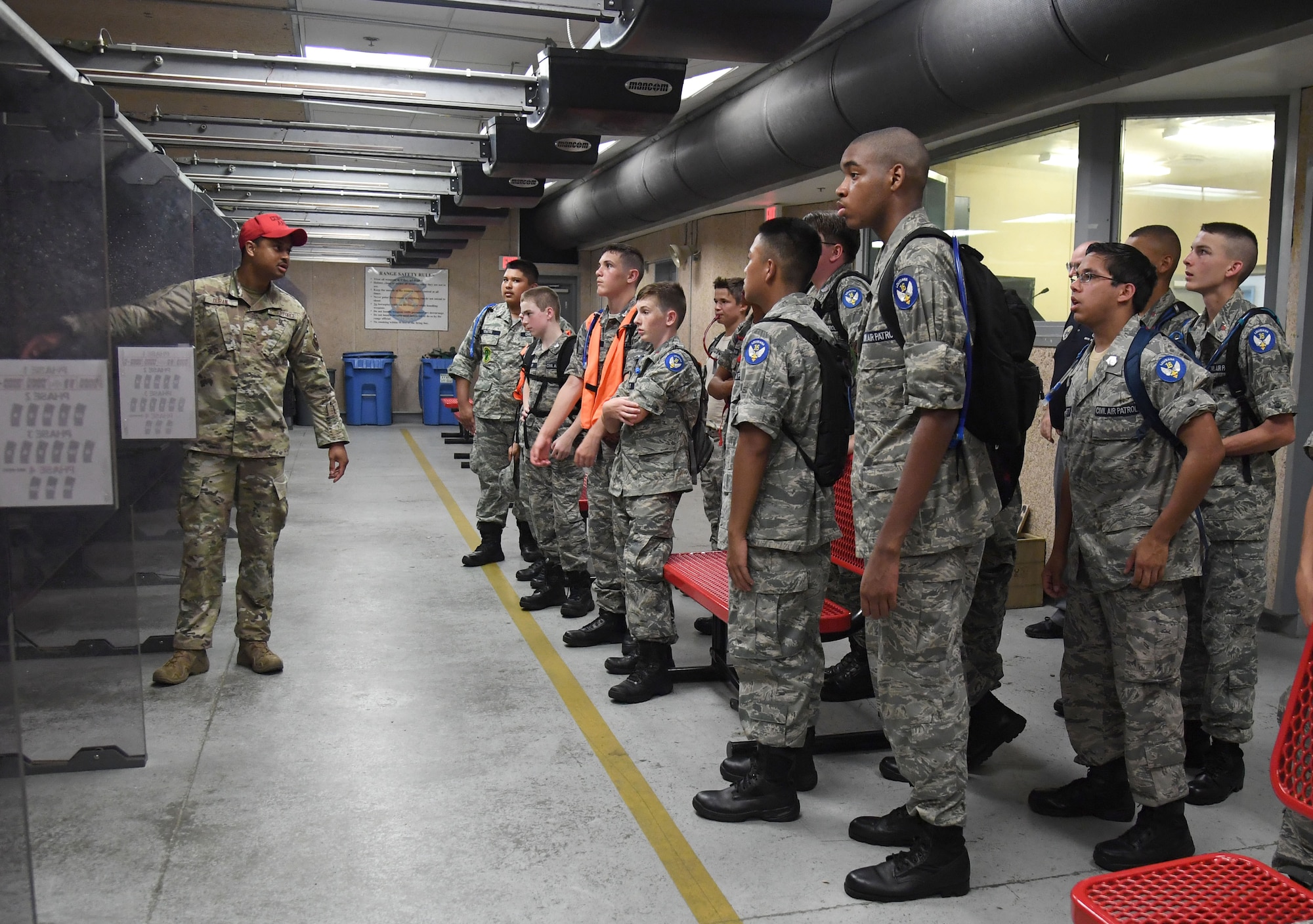 U.S. Air Force Senior Airman Juan Duran, 81st Security Forces Squadron combat arms instructor, briefs Civil Air Patrol cadets on the training capabilities of the indoor firing range at Keesler Air Force Base, Mississippi, July 19, 2022. More than 50 cadets attended the Louisiana Wing Encampment at Keesler from July 14-24. (U.S. Air Force photo by Kemberly Groue)