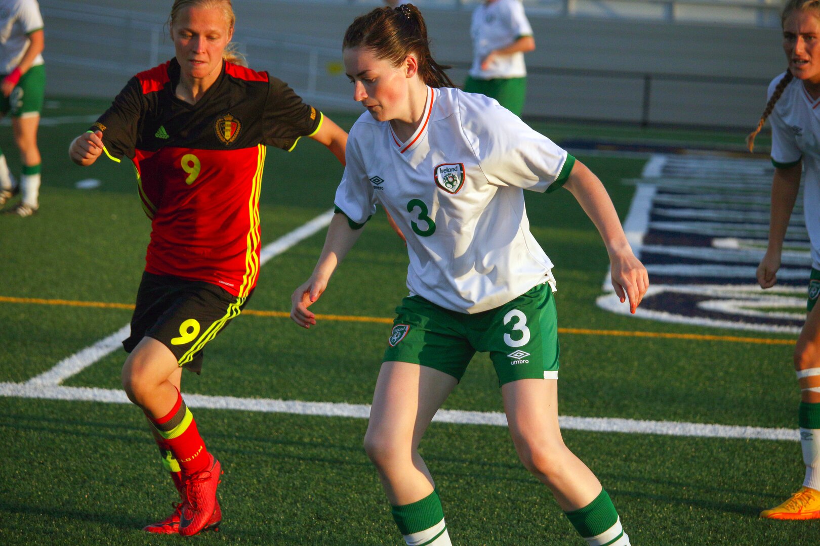 Ireland's #3 Leah Walsh and Belgium's #9 Laura Vanlerberghe go after the ball in match 14 of the 13th Conseil International du Sport Militaire (CISM) World Women's Military Football Championship hosted by Fairchild Air Force Base in Spokane, Washingon.  This year's championship features teams from the United States, Belgium, Cameroon, Canada, France, Germany, Ireland, Mali, Netherlands, and South Korea.  (Department of Defense Photo by Mr. Steven Dinote, released).