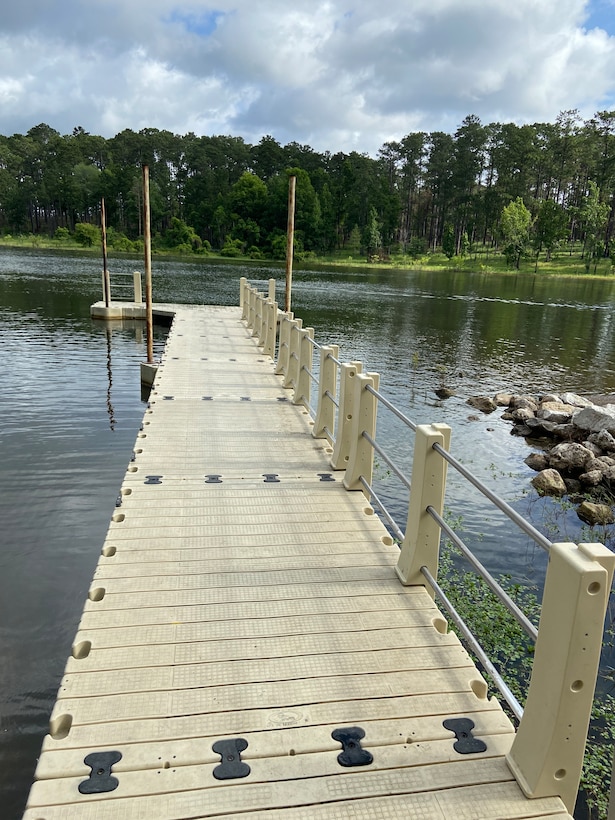 image showing courtesy dock with accessible hand rails at a boat ramp on a lake