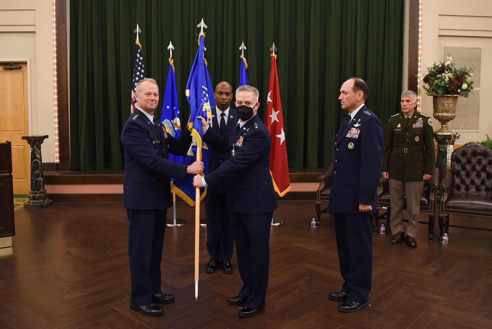 U.S. Air Force Lt. Gen. Timothy Haugh (left), 16th Air Force (Air Forces Cyber) passes the guidon to Gen. Mark Kelly, commander of Air Combat Command, symbolizing the end of his command during a change of command ceremony at Joint Base San Antonio-Lackland, Texas, July 21, 2022.
