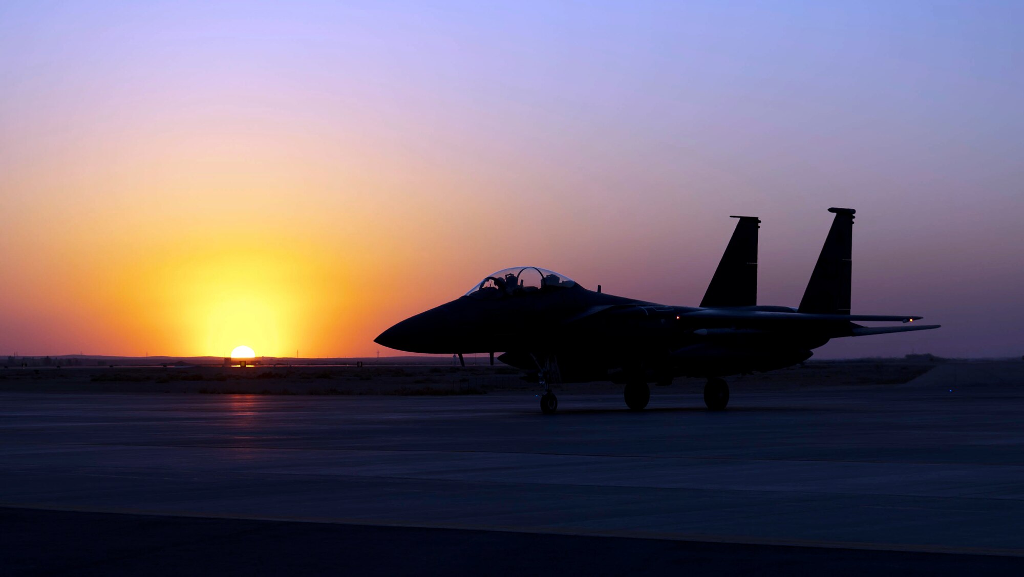 An F-15E Strike Eagle prepares for flight during a sunseT