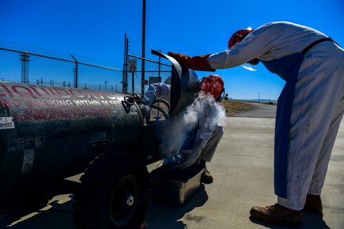 enior Airman Verdes Cato, observes Airman 1st Class Randy Willis 9th Logistic Readiness Squadron cryogenics technician, as he carefully handles Liquid Oxygen (LOX), while a U-2 Dragon Lady flies over at Beale Air Force Base, California, July 21, 2022.