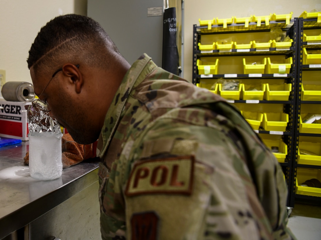 Senior Airman Verdes Cato, 9th Logistic Readiness Squadron cryogenics technician, smells the Liquid Oxygen (LOX) in the beaker at Beale Air Force Base, California, July 21, 2022