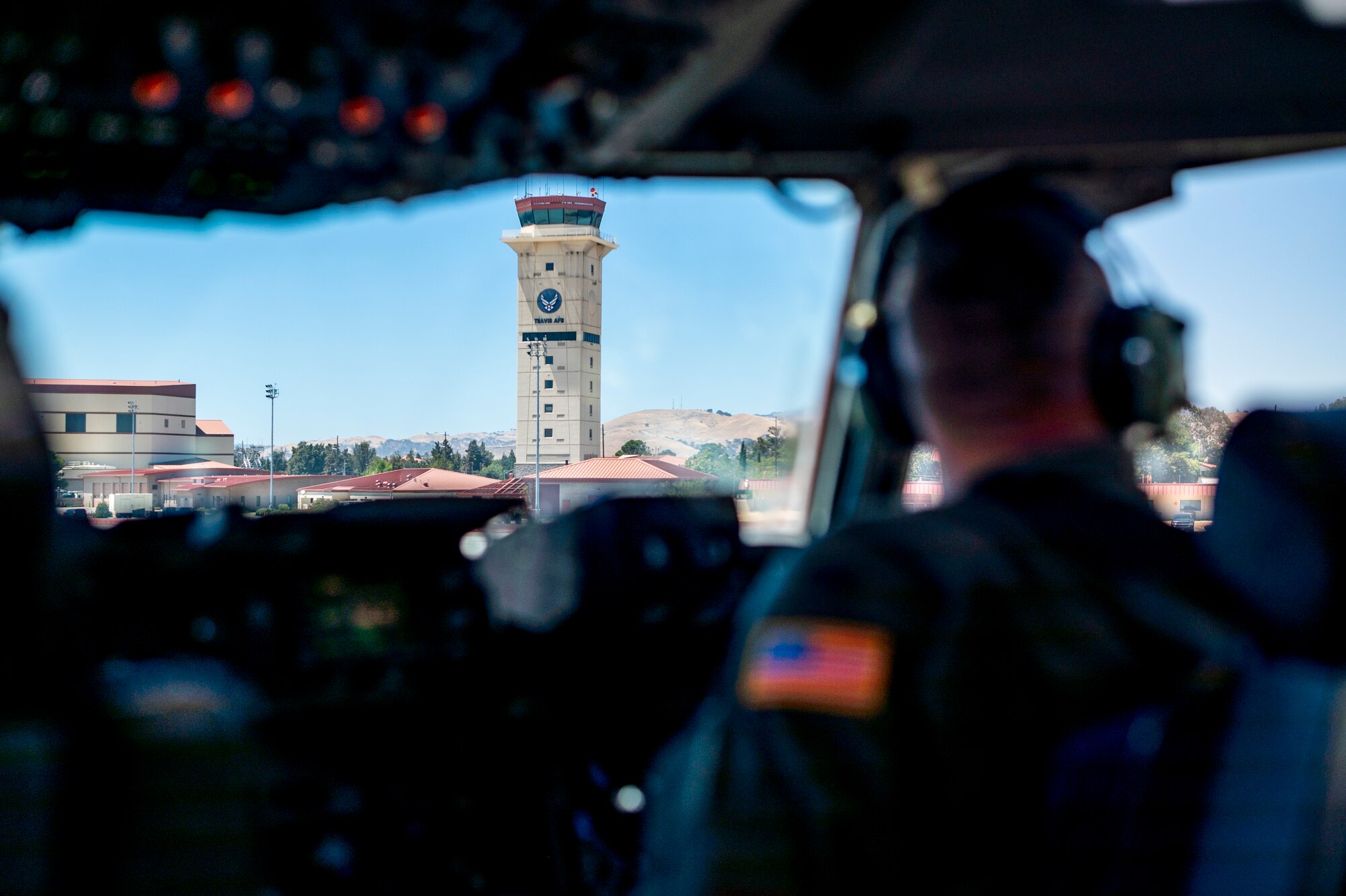 A photo of the control tower from the flight deck of an airplane