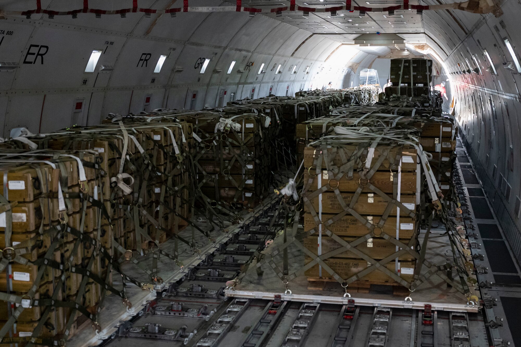 Pallets of ammunition bound for Ukraine are secured onto a commercial plane during a security assistance mission at Dover Air Force Base, Delaware, July 21, 2022. The Department of Defense is providing Ukraine with critical capabilities to defend against Russian aggression under the Ukraine Security Assistance initiative. (U.S. Air Force photo by Senior Airman Faith Schaefer)